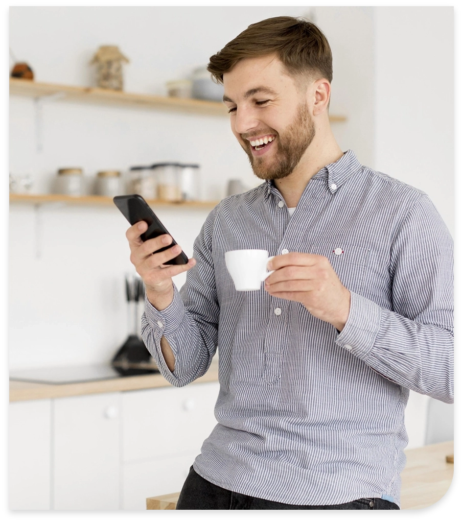 portrait-man-drinking-coffee-while-checking-mobile@2x